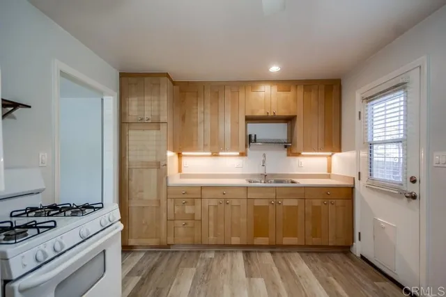a kitchen with a sink stove and cabinets