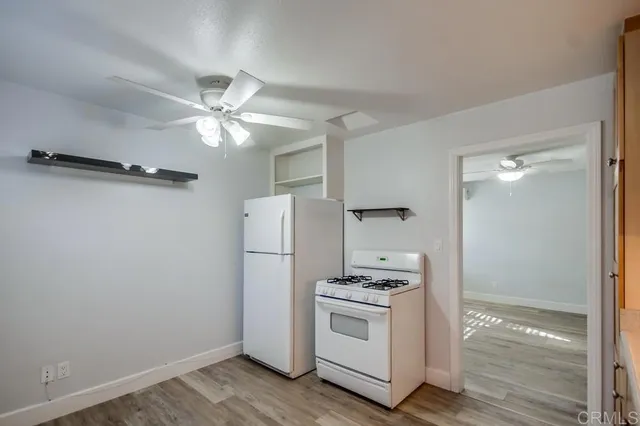 a kitchen with a refrigerator and a stove top oven