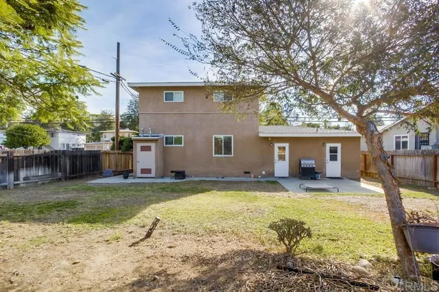 a view of a house with a yard and sitting area