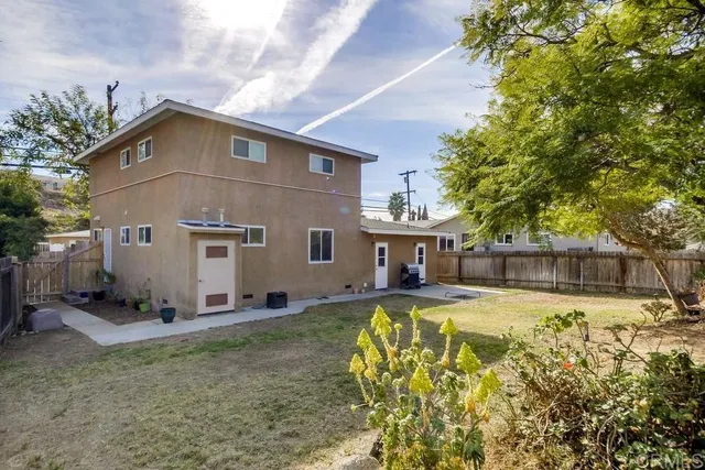 a view of a house with pool and sitting area