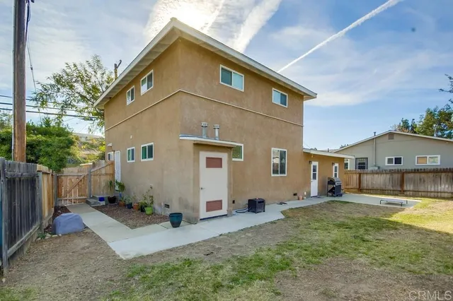 a view of a yard in front view of a house