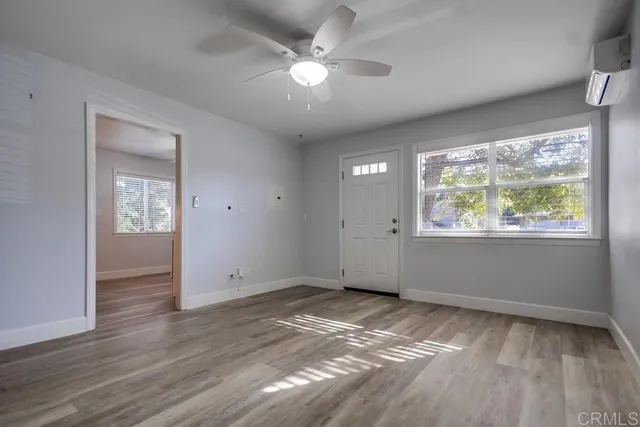 wooden floor in an empty room with a window