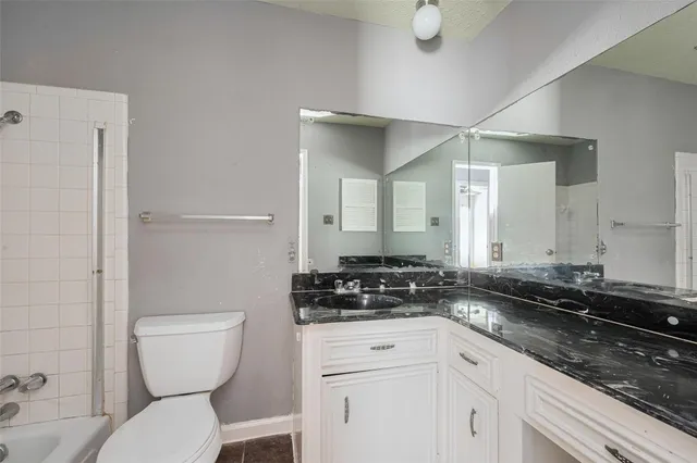 a bathroom with a toilet sink and shower curtain