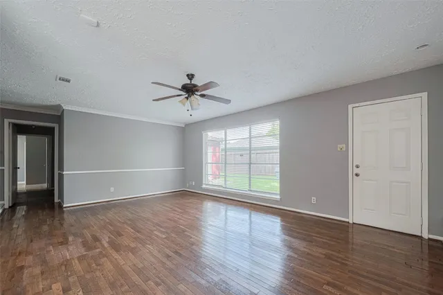 a large kitchen with granite countertop a sink and cabinets