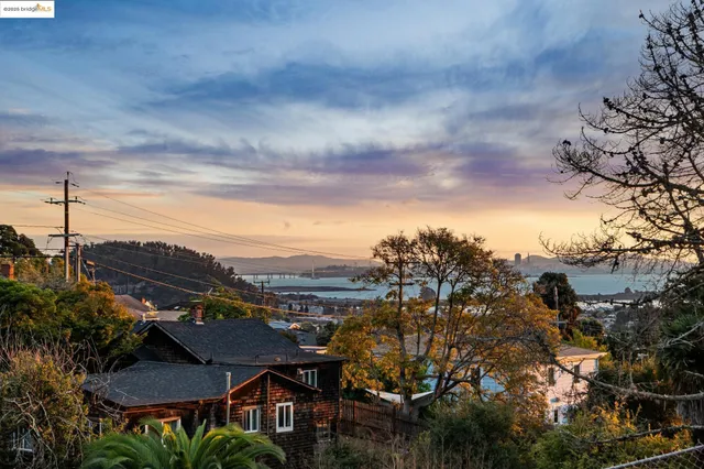a view of a city with lots of residential buildings around and wooden fence
