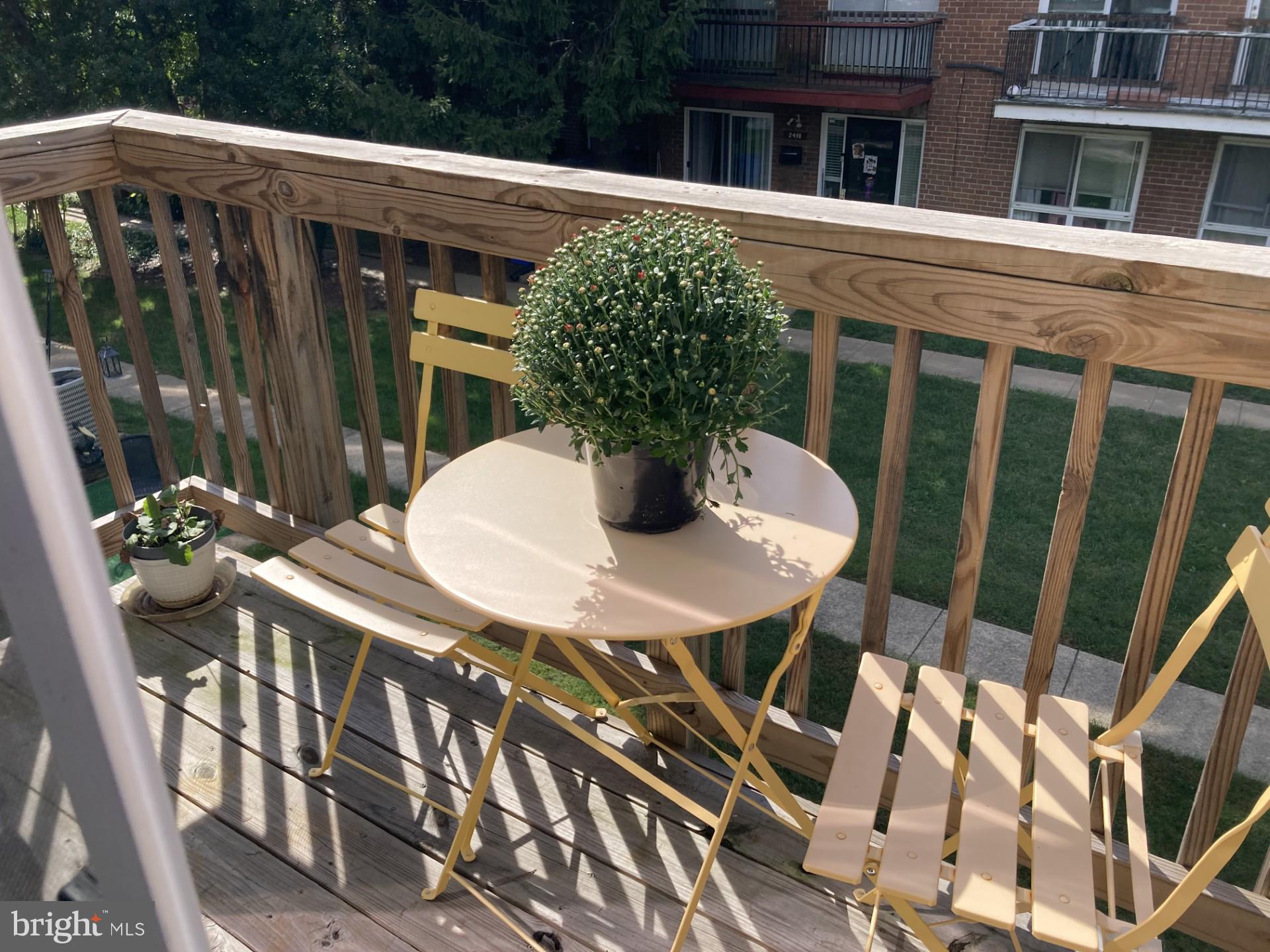2310 Sun Valley Circle, Unit 1D Silver Spring, MD 20906 - Photo 11 of 20 a view of a balcony dining table and chairs