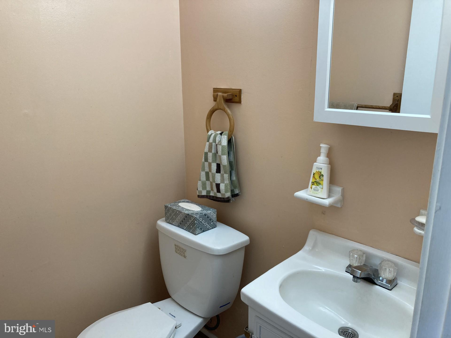 2310 Sun Valley Circle, Unit 1D Silver Spring, MD 20906 - Photo 12 of 20 a bathroom with a toilet sink and mirror