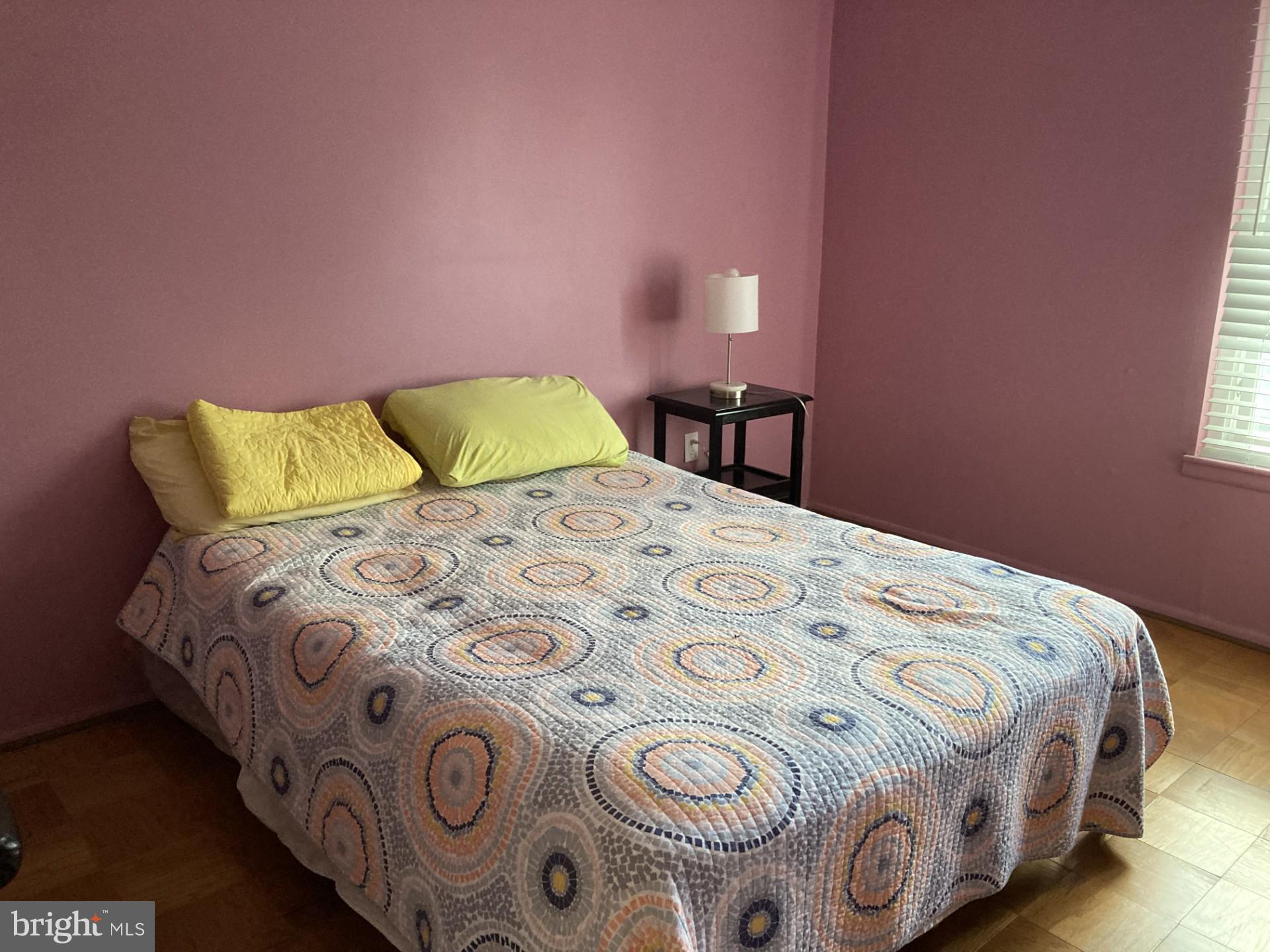 2310 Sun Valley Circle, Unit 1D Silver Spring, MD 20906 - Photo 17 of 20 a bedroom with a bed and a chair