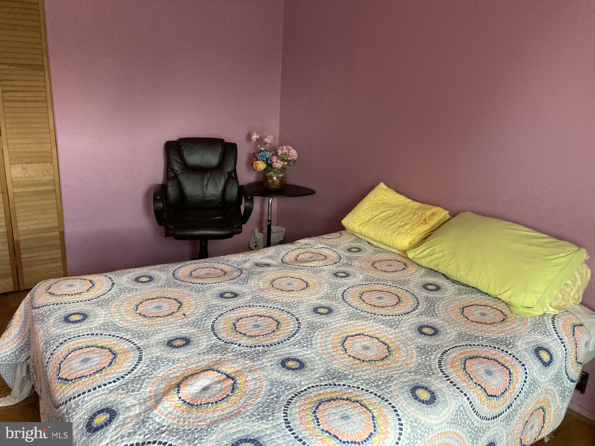 2310 Sun Valley Circle, Unit 1D Silver Spring, MD 20906 - Photo 18 of 20 a bedroom with a bed and a table