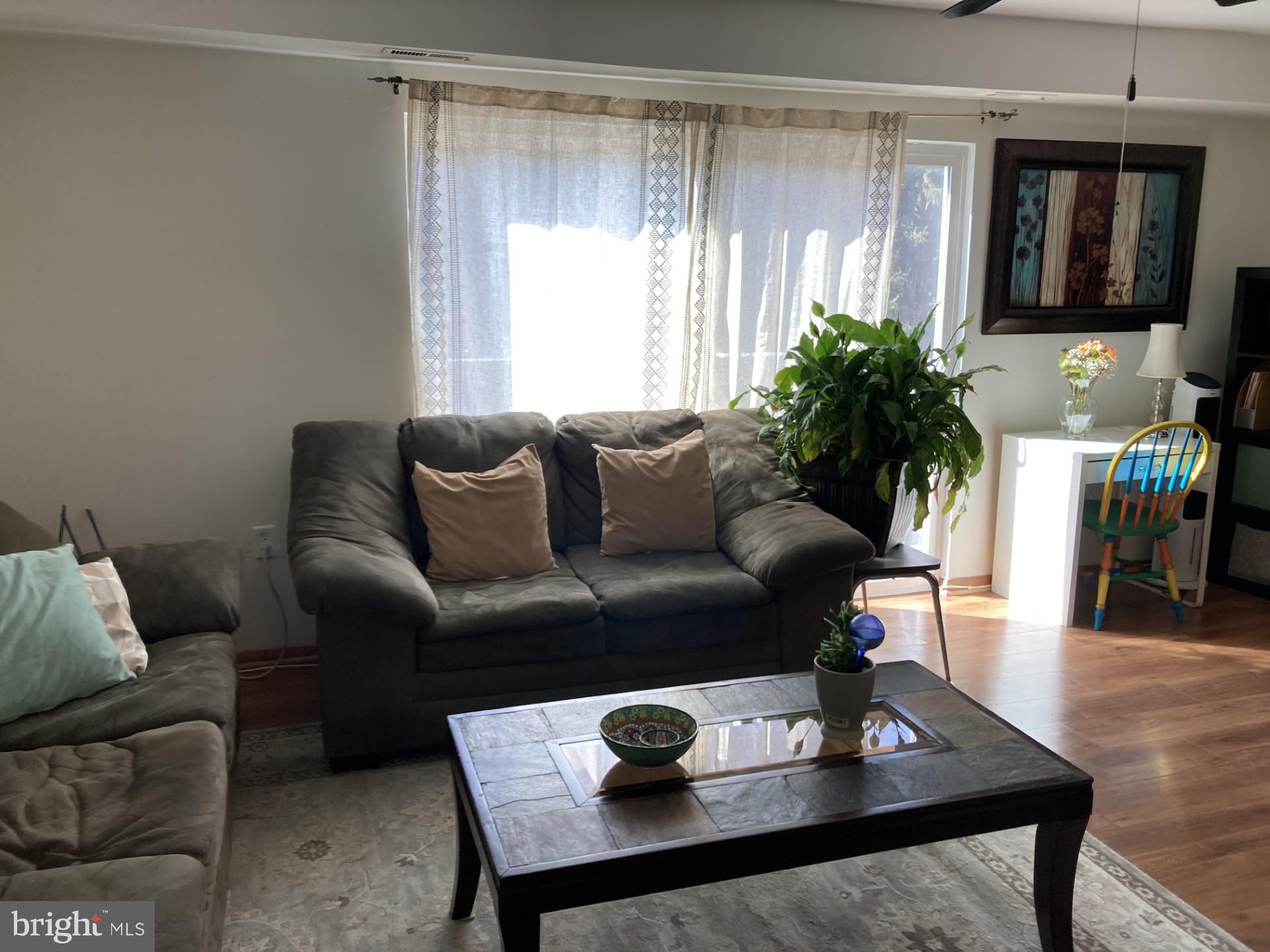 2310 Sun Valley Circle, Unit 1D Silver Spring, MD 20906 - Photo 9 of 20 a living room with furniture and a window