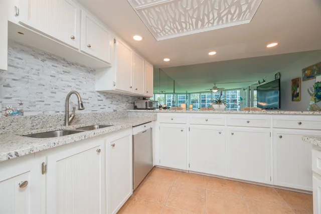 a view of a kitchen with granite countertop cabinets
