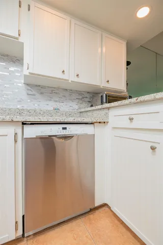 a kitchen with metallic refrigerator freezer and a dishwasher
