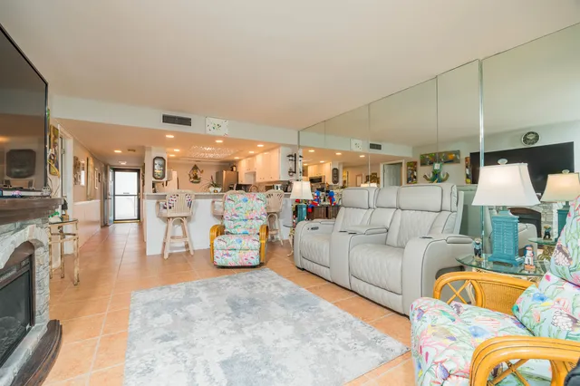 a dining room with furniture and a floor to ceiling window