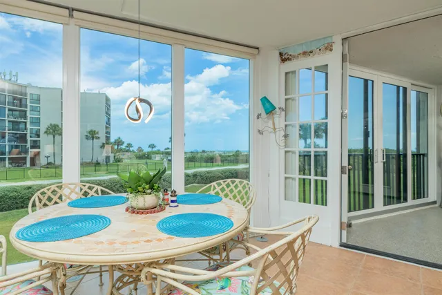 a view of a balcony with furniture and garden