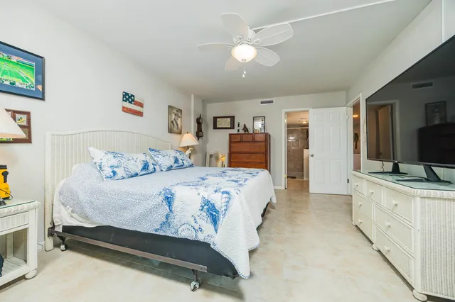 a kitchen with white cabinets and appliances
