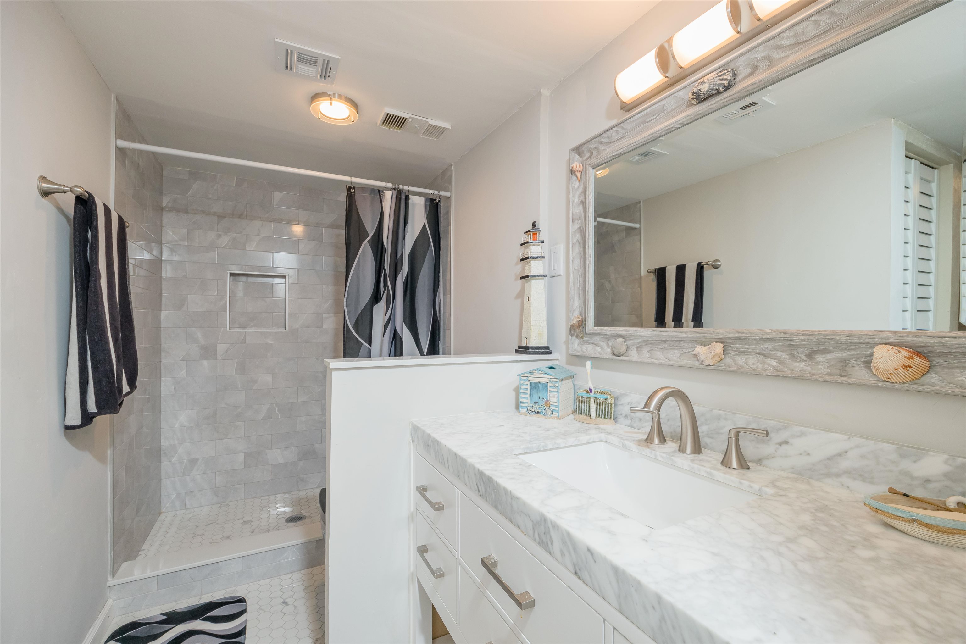 1 Dondanville Road, Unit 116C St. Augustine, FL 32080 - Photo 30 of 59 a bathroom with a granite countertop sink mirror and shower