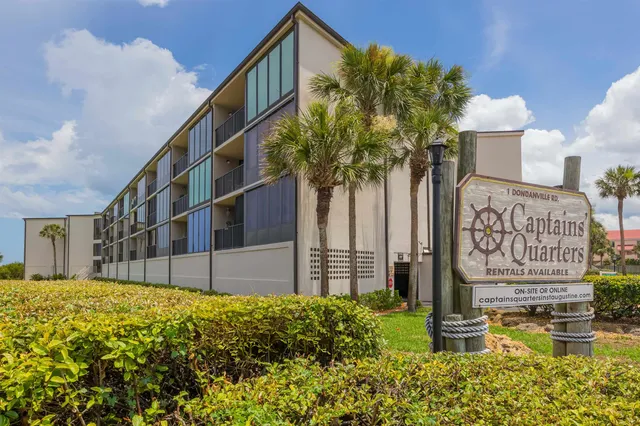 a street view with tall buildings and a yard