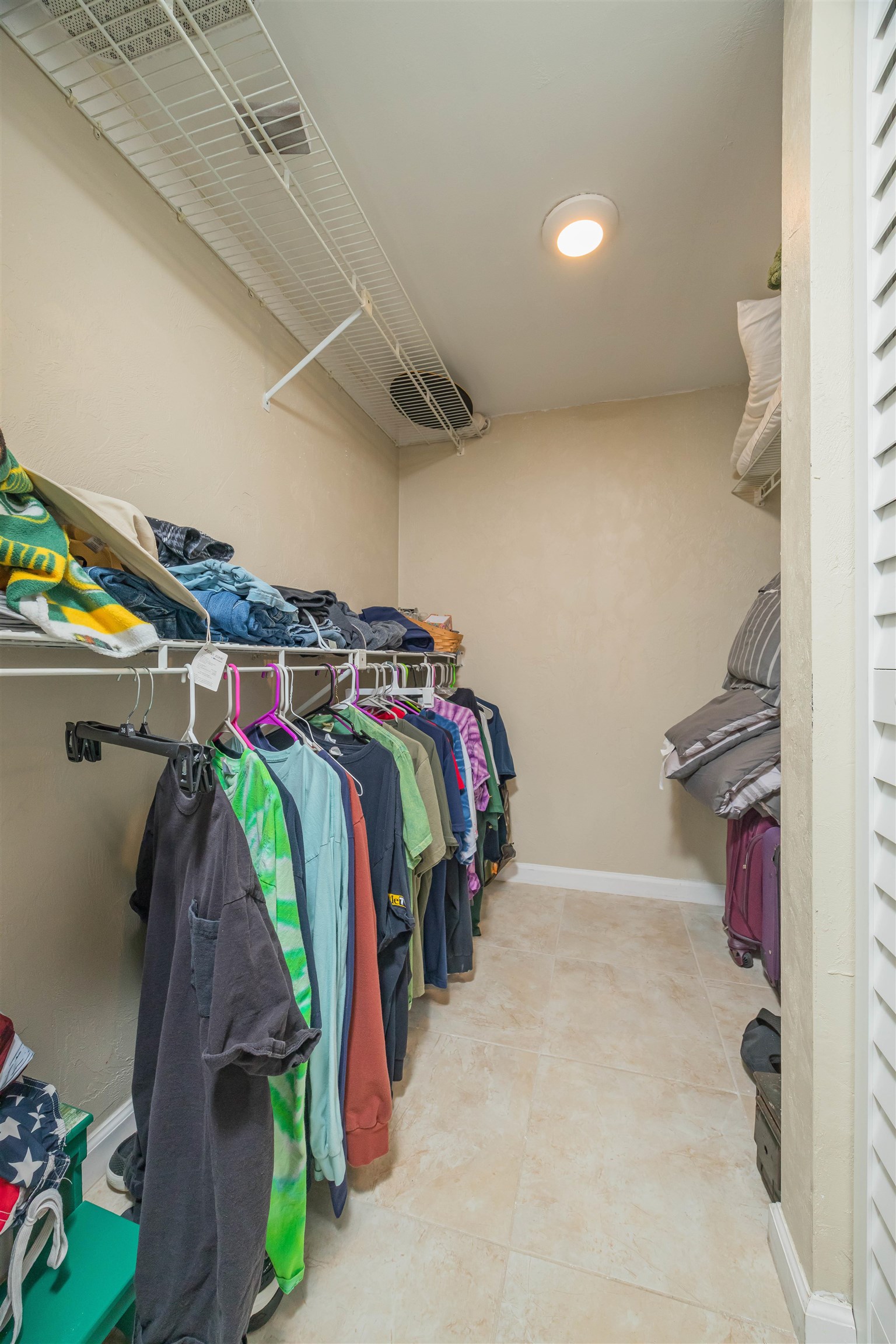 1 Dondanville Road, Unit 116C St. Augustine, FL 32080 - Photo 33 of 59 a view of walk in closet with clothes and shoes