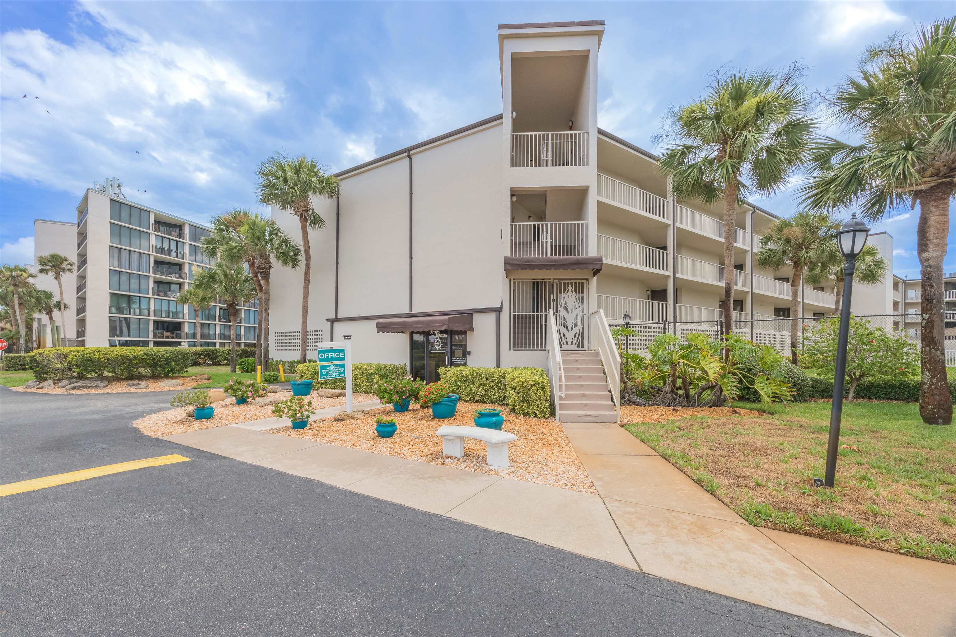 1 Dondanville Road, Unit 116C St. Augustine, FL 32080 - Photo 4 of 59 a street view with tall buildings and a yard