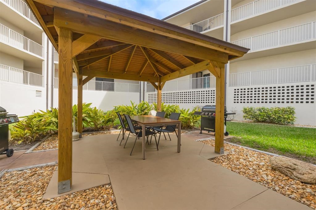 1 Dondanville Road, Unit 116C St. Augustine, FL 32080 - Photo 44 of 59 a view of a patio with a table and chairs under an umbrella