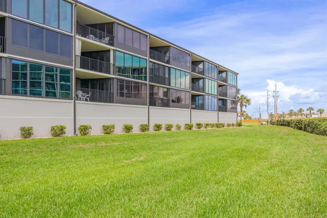 a view of a brick building next to a yard