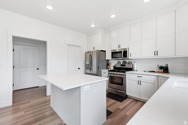 347 Ropelato Drive Logan, UT 84321 - Photo 13 of 46 Modern kitchen featuring a central island with a white countertop