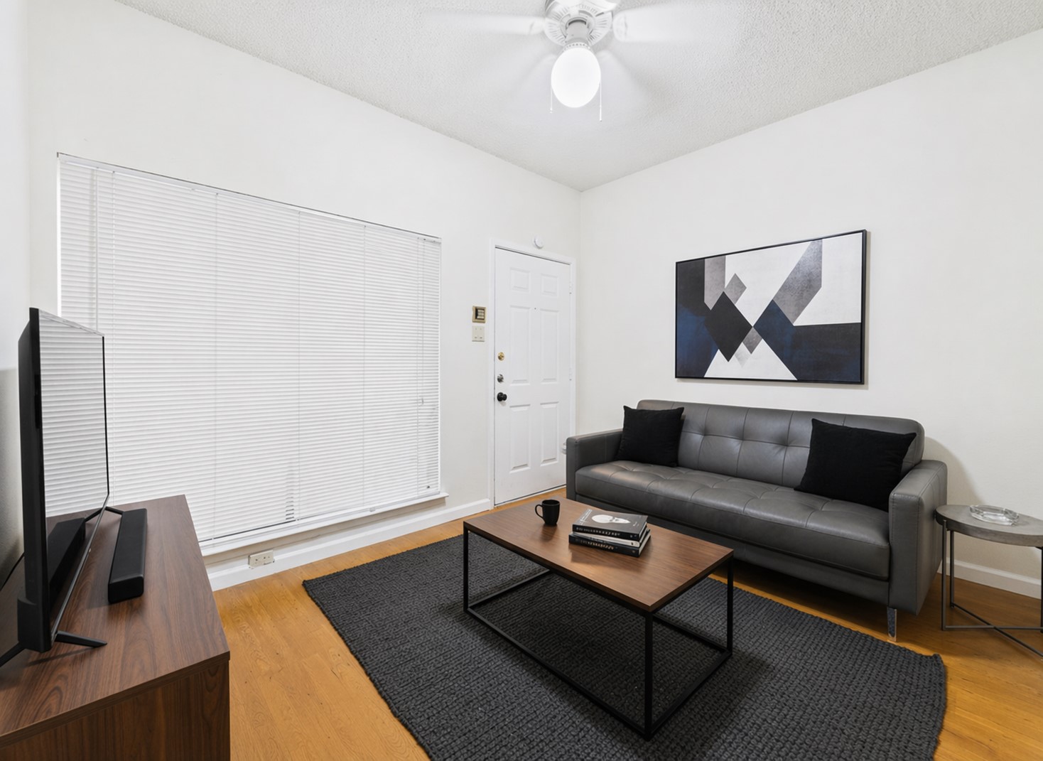 2815 Rio Grande Street, Unit 109 Austin, TX 78705 - Photo 1 of 25 a living room with furniture and a flat screen tv