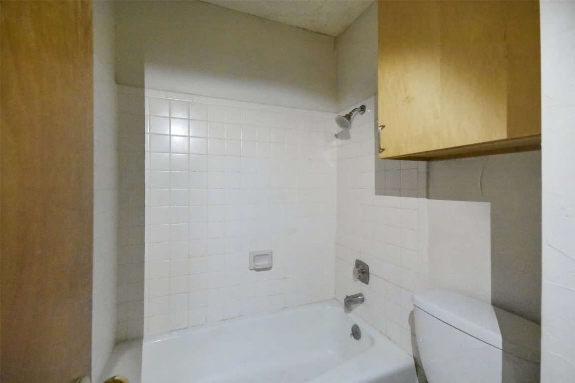 2815 Rio Grande Street, Unit 109 Austin, TX 78705 - Photo 11 of 20 a bathroom with a bathtub and shower