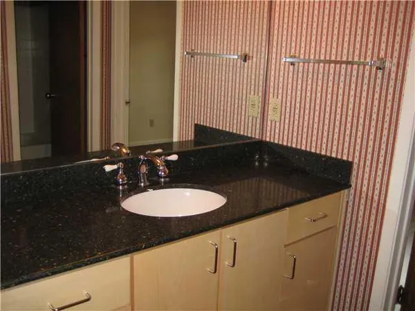 a view of storage and utility room with wooden floor