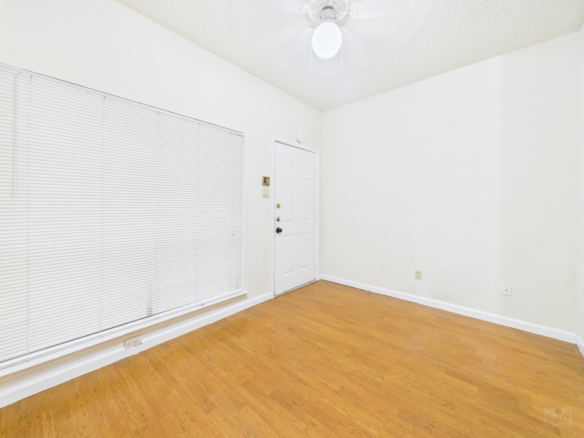 2815 Rio Grande Street, Unit 109 Austin, TX 78705 - Photo 23 of 25 an empty room with a fan and a window