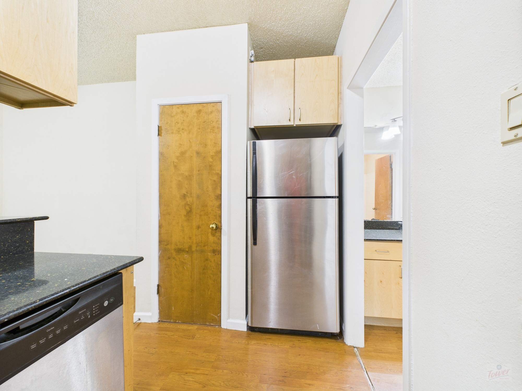 2815 Rio Grande Street, Unit 109 Austin, TX 78705 - Photo 3 of 25 a kitchen with a refrigerator and a stove