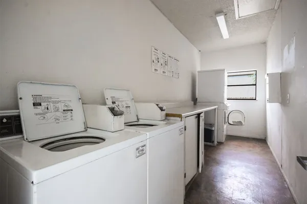 a kitchen with a sink cabinets and a wooden floor