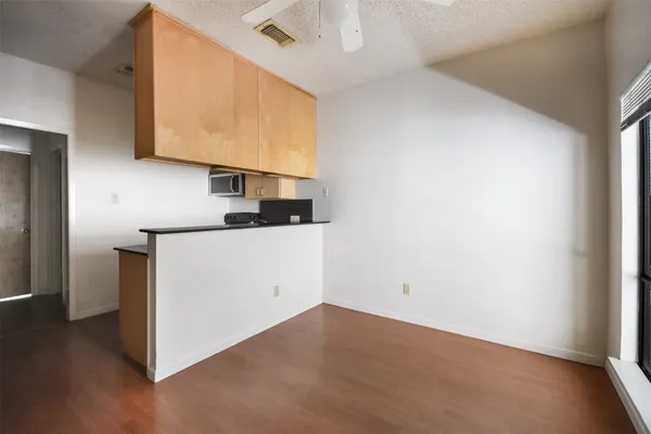 a view of storage and utility room with wooden floor