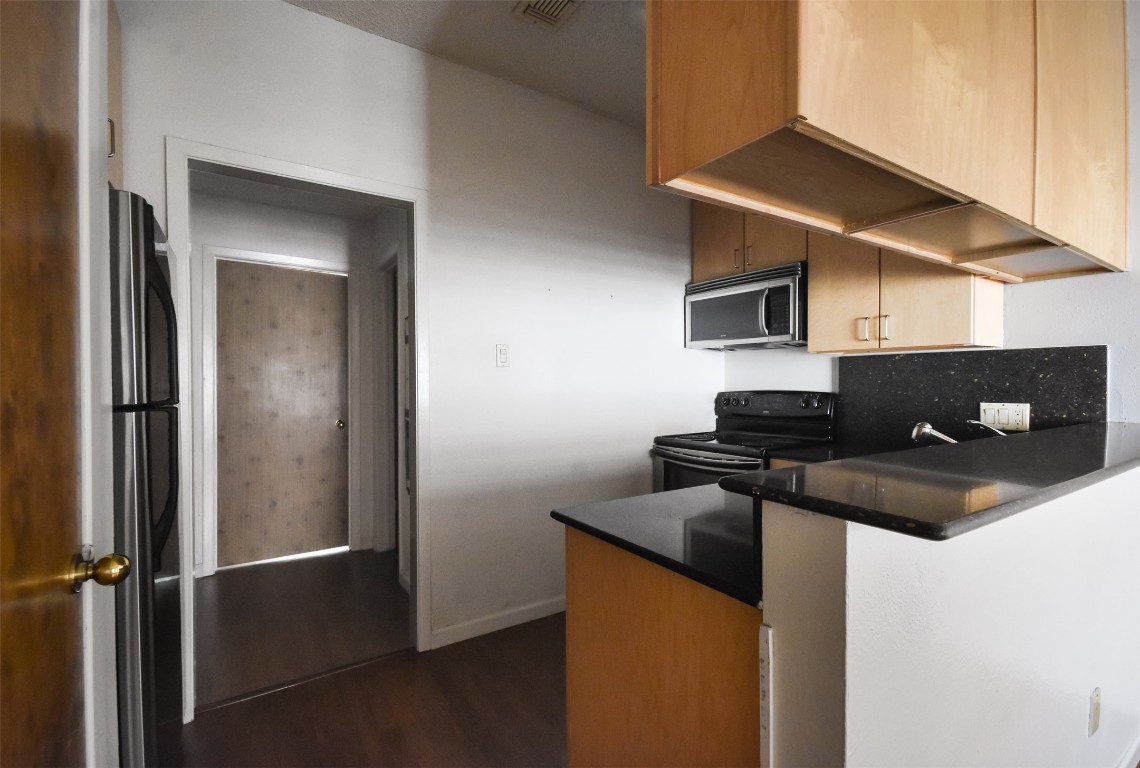 2815 Rio Grande Street, Unit 109 Austin, TX 78705 - Photo 8 of 20 a kitchen with a sink and a refrigerator