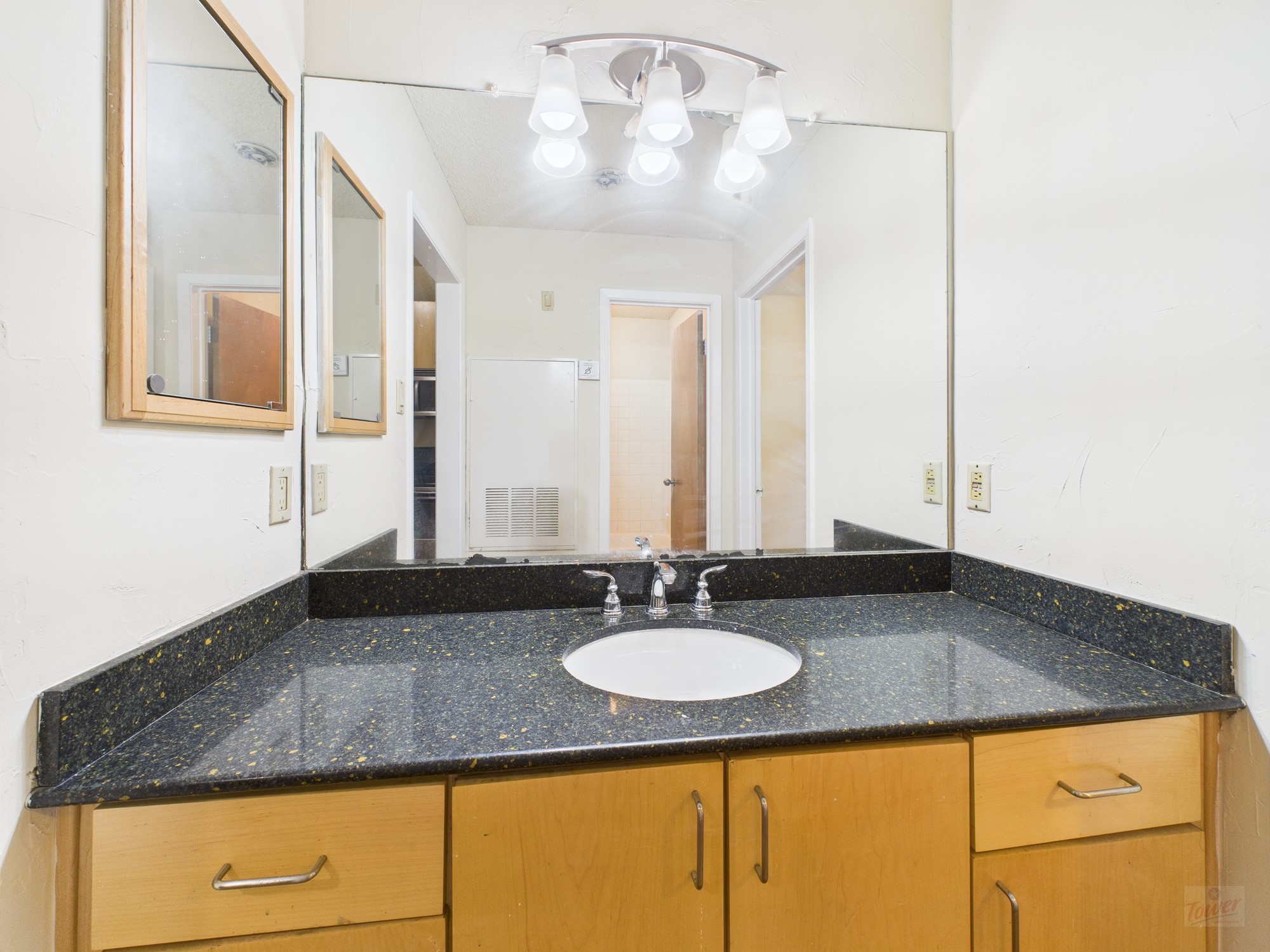 2815 Rio Grande Street, Unit 109 Austin, TX 78705 - Photo 9 of 25 a bathroom with a granite countertop sink and a mirror