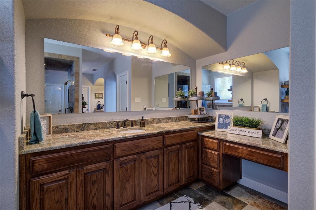 9199 Fm 1810 Chico, TX 76431 - Photo 13 of 40 a bathroom with a granite countertop sink and a mirror