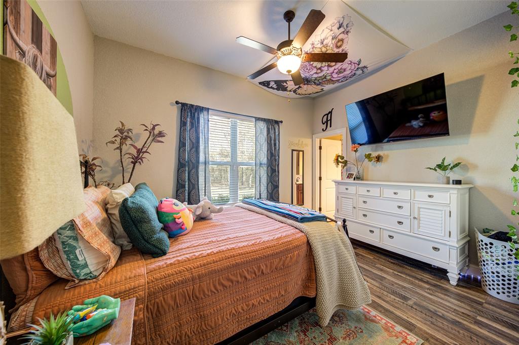 9199 Fm 1810 Chico, TX 76431 - Photo 18 of 40 a bedroom with a bed and a flat screen tv