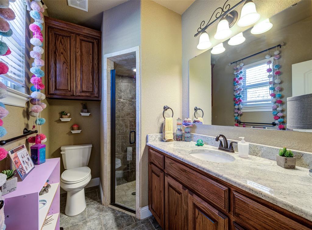 9199 Fm 1810 Chico, TX 76431 - Photo 19 of 40 a bathroom with a granite countertop toilet sink and mirror