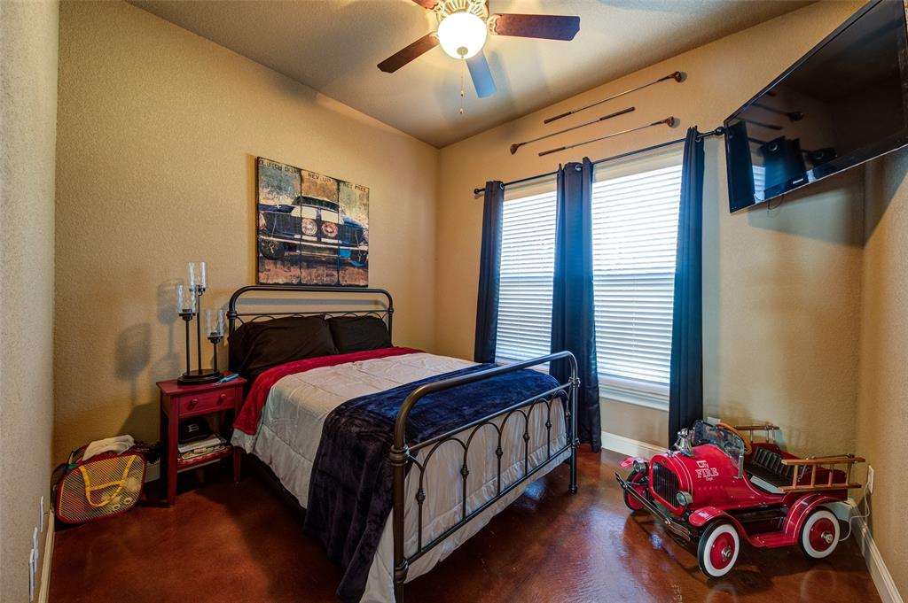9199 Fm 1810 Chico, TX 76431 - Photo 20 of 40 a bedroom with a bed and a chandelier