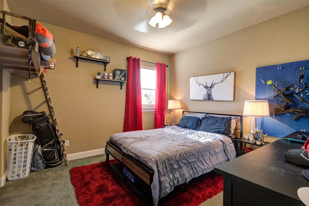 9199 Fm 1810 Chico, TX 76431 - Photo 23 of 40 a bedroom with a bed and a dresser with the shoe rack