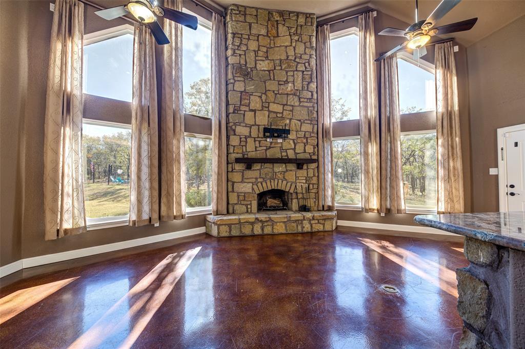 9199 Fm 1810 Chico, TX 76431 - Photo 28 of 40 a living room with a fireplace with wooden floor