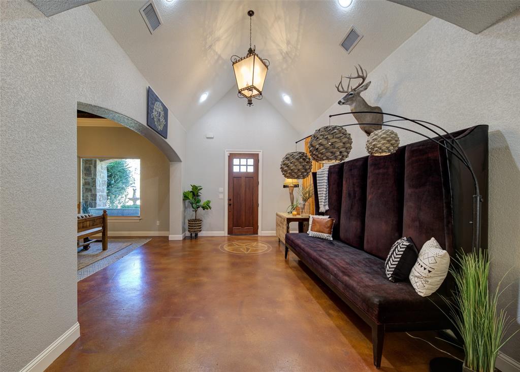 9199 Fm 1810 Chico, TX 76431 - Photo 5 of 40 a living room with couches chandelier and a dining table with wooden floor