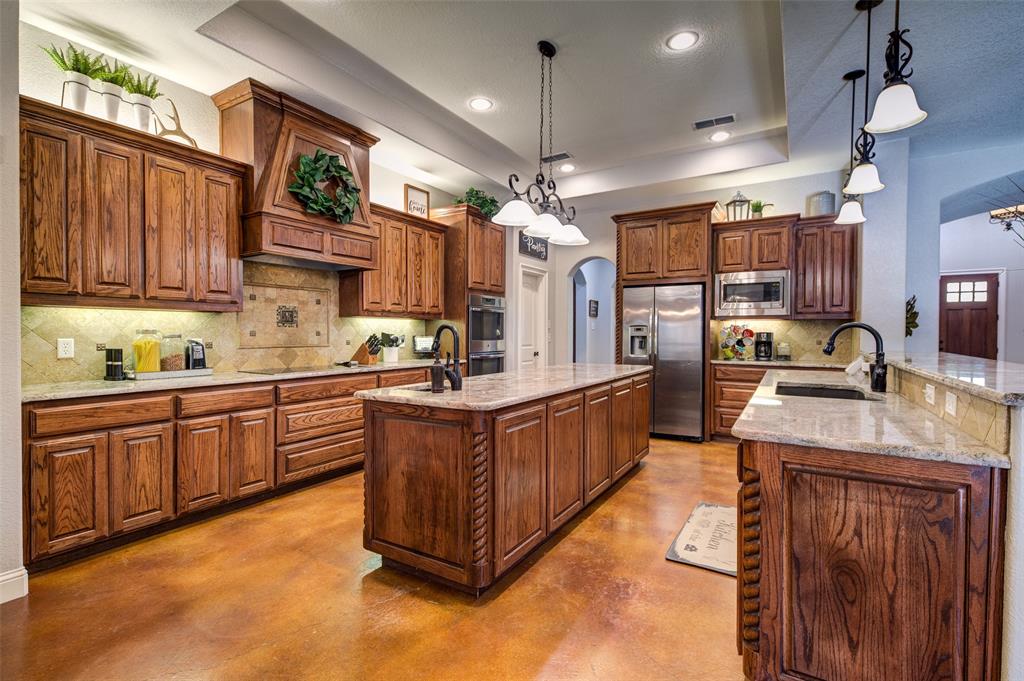 9199 Fm 1810 Chico, TX 76431 - Photo 10 of 40 a kitchen with stainless steel appliances granite countertop a stove a sink dishwasher and a refrigerator