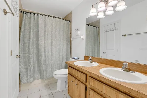 a bathroom with a double vanity sink mirror and toilet