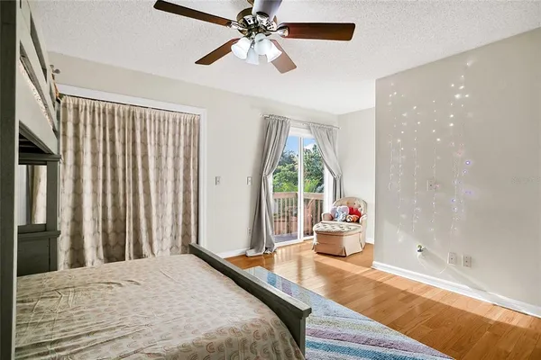 a bedroom with a bed and large windows