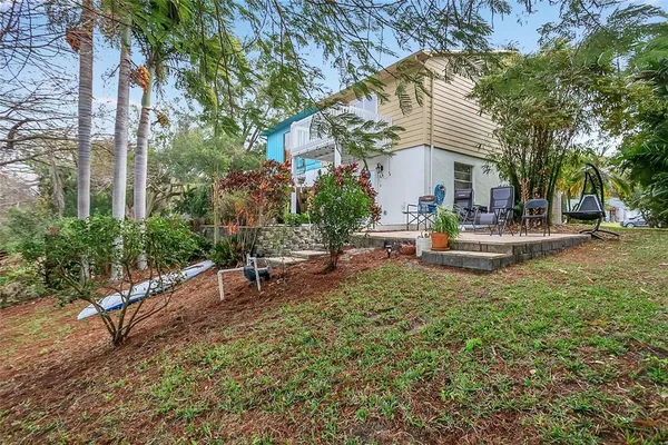 a view of a house with backyard and sitting area
