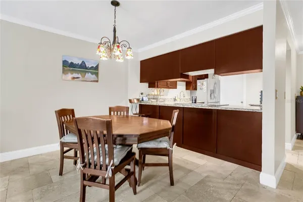 a view of a dining room with furniture a chandelier and wooden floor