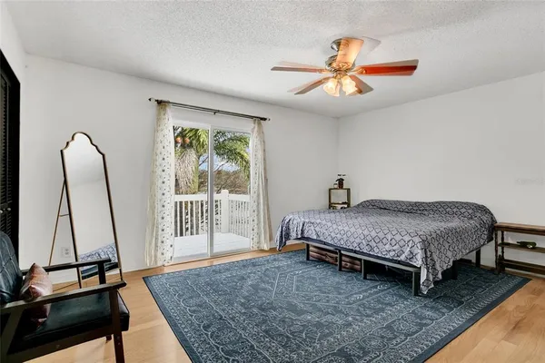 a bedroom with a bed and a flat tv screen on the dresser