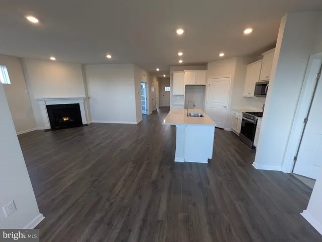 a kitchen with a sink a microwave and cabinets