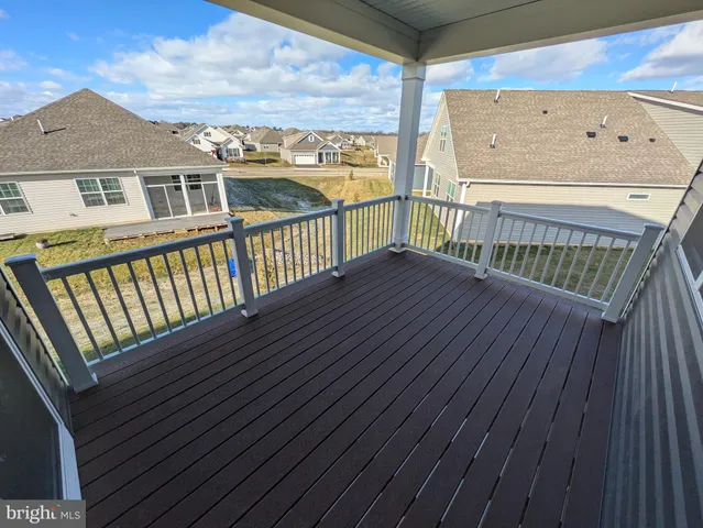 an empty room with wooden floor and window